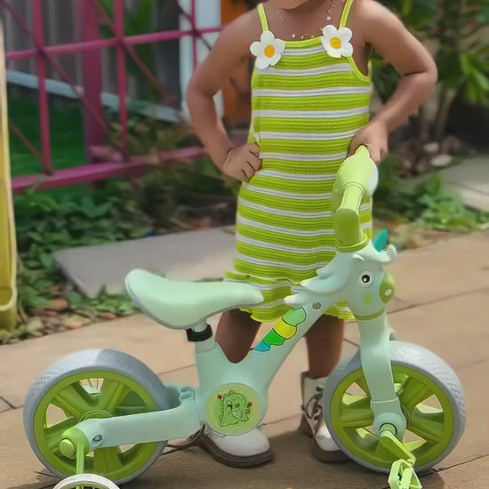 Little girl with AMBERZ KT-293 Unicorn BeatRide 3-in-1 convertible balance bike in mint green with training wheels and pedals