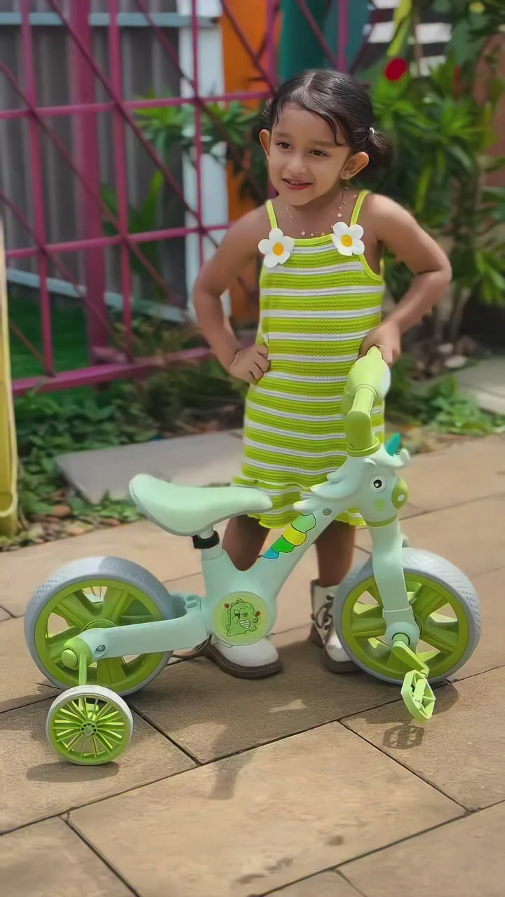 Little girl with AMBERZ KT-293 Unicorn BeatRide 3-in-1 convertible balance bike in mint green with training wheels and pedals